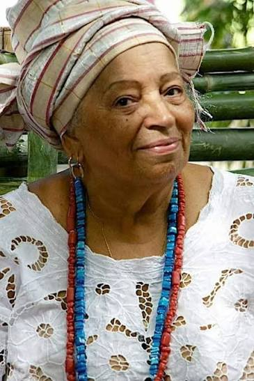 Mãe Juju de Osun, com turbante e colares de Oxum